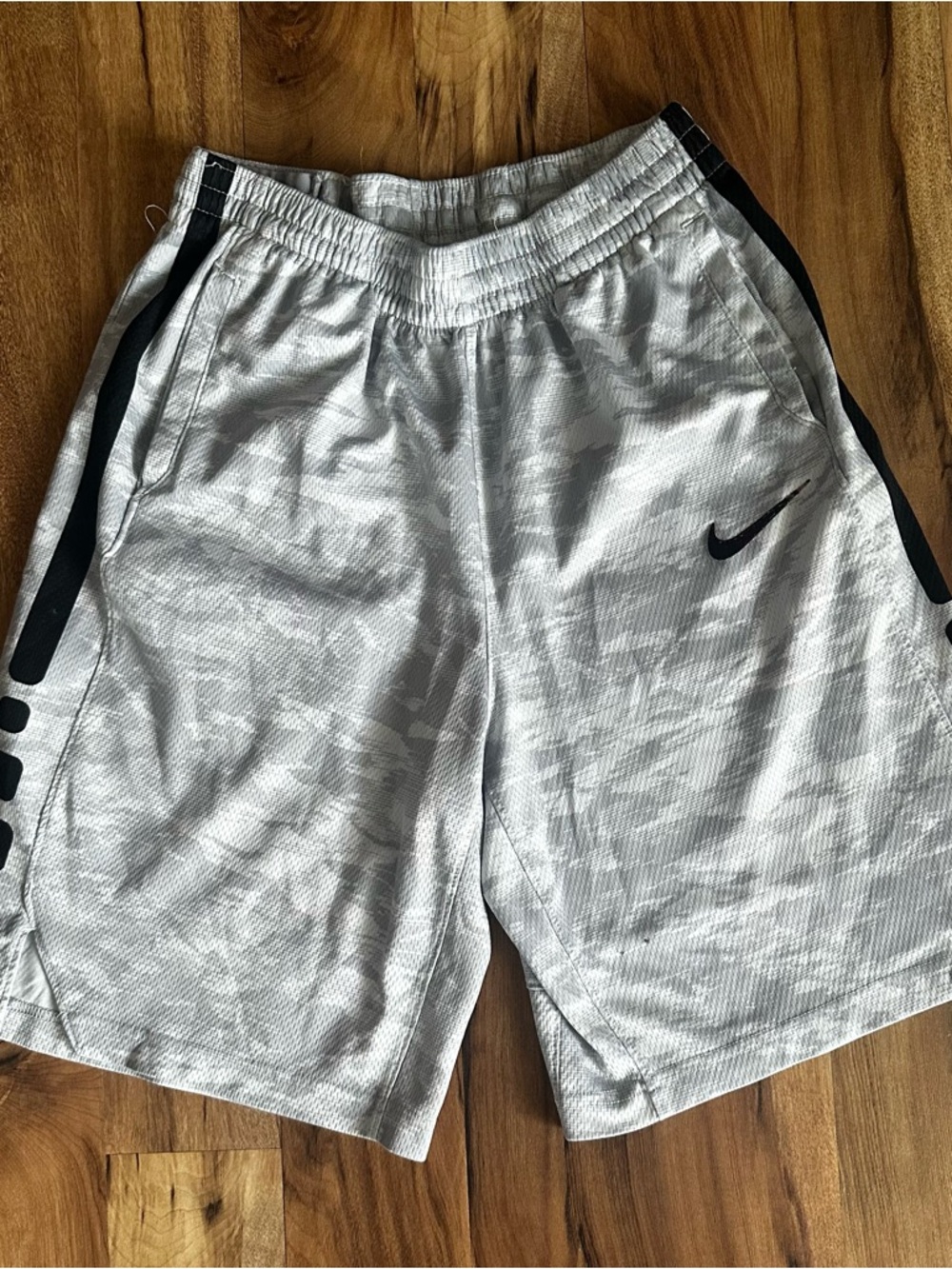 Nike White Athletic Shorts with Black Swoosh and Side Stripes